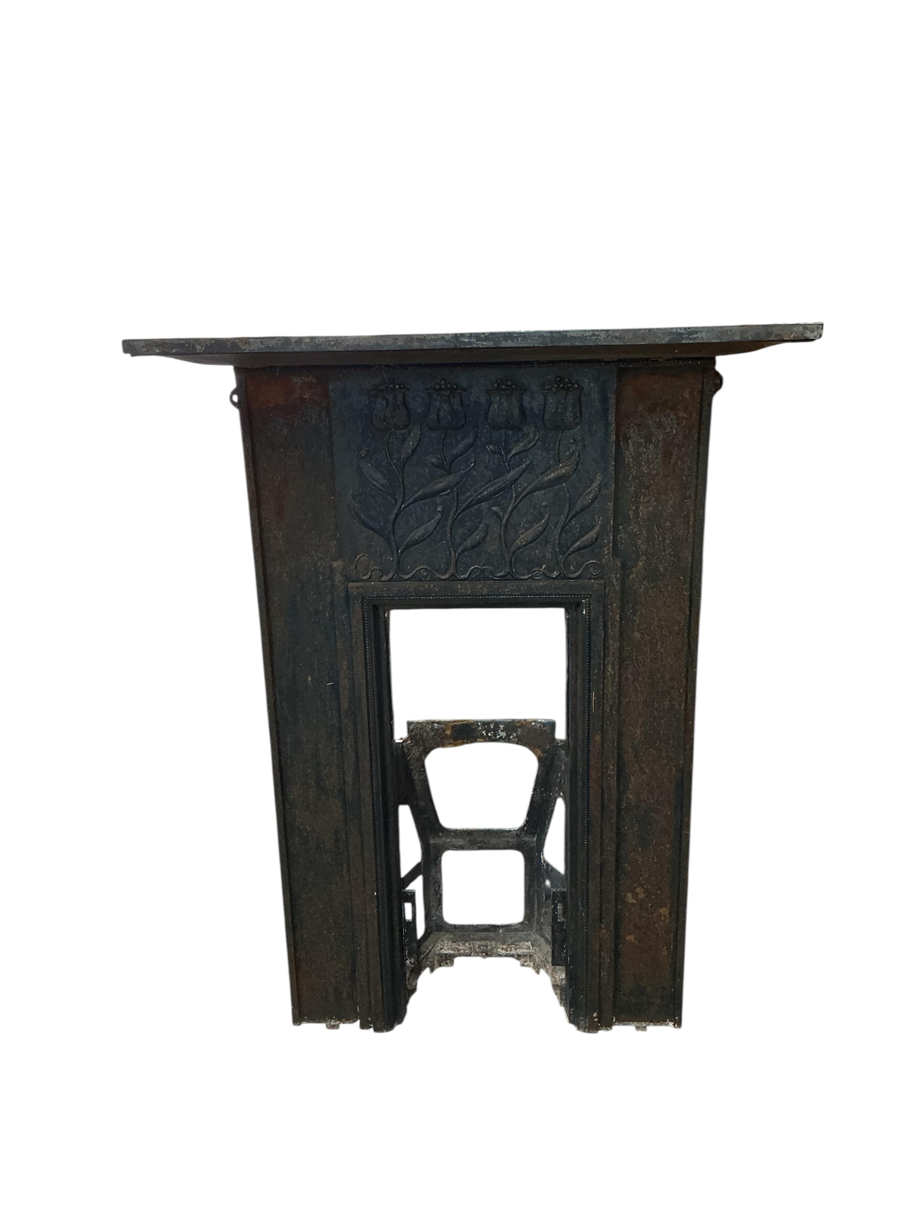 A late Victorian Art Nouveau cast iron fire surround, with tulip design, width 94cm, height 126cm